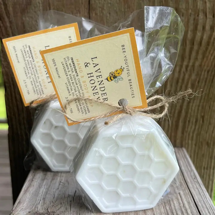 two white honey comb detail soap bars sitting side by side in packaging with large orange tag