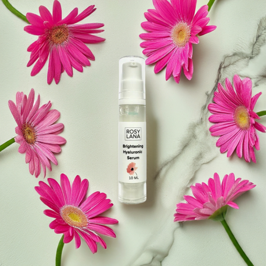 bottle surrounded by pink daisies