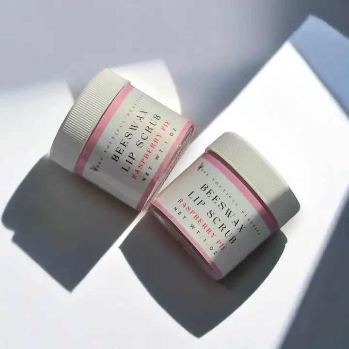 two jars of raspberry lip scrubs sitting next to each other